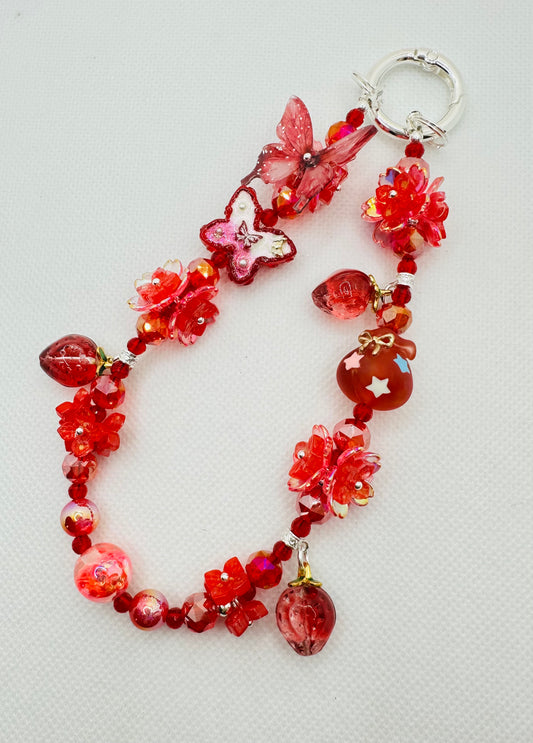 Bold red strawberry bag charm
